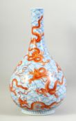 A GOOD LARGE CHINESE BOTTLE VASE painted with numerous dragons in coral-red against blue and white