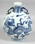 A CHINESE BLUE AND WHITE PORCELAIN TWIN-HANDLED MOON FLASK, the body painted with large dragon and