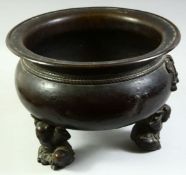 A VERY LARGE CHINESE BRONZE TRIPOD CENSER, the feet formed as crouching figures holding the censer