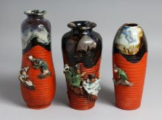 THREE JAPANESE SUMIDA POTTERY VASES, partly glazed with ribbed body and figures in relief, one
