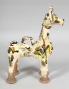 A TURKISH CANAKKALE GLAZED POTTERY FIGURE OF A GIRAFFE, 26cm high.