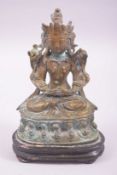 A CHINESE BRONZE FIGURE OF A DEITY, fixed to a wood stand, 14cm high.