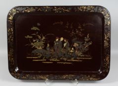A LARGE LACQUERED WOOD CHINOISERIE TRAY, the centre decorated with figures, the border with gilt