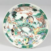 A CHINESE FAMILLE VERTE PORCELAIN DISH, in the Kang-Xi style, decorated with warriors on horseback