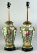 A PAIR OF CHINESE CANTON FAMILLE ROSE PORCELAIN LAMP VASES, painted with panels of figures as well