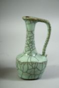 A SMALL CHINESE CELADON CRACKLE GLAZE OIL VESSEL, 12.5cm high.
