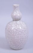A CHINESE KANGXI PERIOD GUAN GLAZE DOUBLE GOURD PORCELAIN VASE, with a small museum repair to