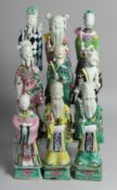A COLLECTION OF NINE CHINESE FAMILLE ROSE PORCELAIN IMMORTAL FIGURES, the tallest 23.5cm high