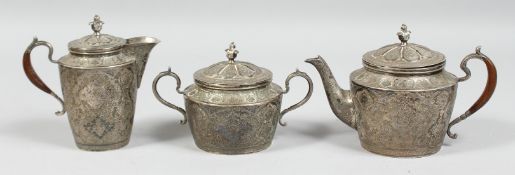 A FINE SIGNED PERSIAN THREE PIECE TEA SET, the teapot and jug with wooden handle, each piece with