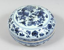 A CHINESE BLUE AND WHITE PORCELAIN CIRCULAR BOX AND COVER, decorated with phoenix and lotus, the rim