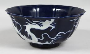 A CHINESE SACRIFICIAL BLUE PORCELAIN BOWL, the exterior decorated with white dragons and flaming