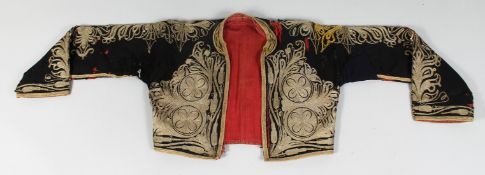 A 19TH CENTURY TURKISH OTTOMAN SHORT JACKET, embroidered with gilt thread.