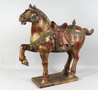A LARGE 19TH/20TH CENTURY CARVED WOODEN 'TANG' HORSE, the body with red and gold lacquer, the
