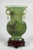 A SMALL CHINESE CHINESE CARVED JADE TWIN-HANDLED MINIATURE VASE AND FITTED STAND, with drop-ring
