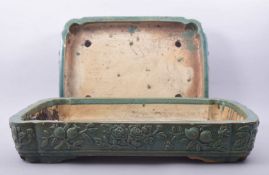 TWO LARGE CHINESE GREEN GLAZED RECTANGULAR PLANTERS, with raised floral decoration, 51cm x 38cm