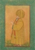 A Persian Gajar miniature painting of a figure, in a micro mosaic inlaid frame, glazed, 12.5
