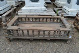 An Indian hardwood rectangular cradle or plant trough with turned spindle supports.