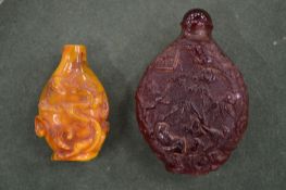 Two Chinese amber style snuff bottles.