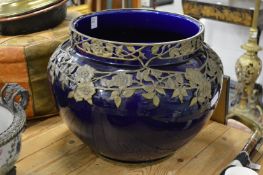 A large blue ground pottery jardiniere with metal mounts.