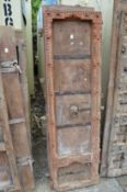 A pair of Indian carved hardwood doors with wrought iron mounts.