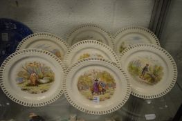 A set of seven Minton allegorical plates with pierced borders.