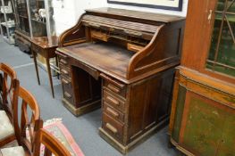 An oak roll top pedestal desk.