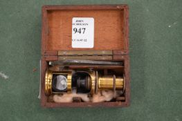 A miniature microscope in a mahogany case.