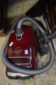 A Miele compact vacuum cleaner.