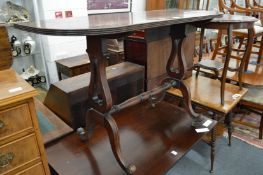 A mahogany D-shaped side table on lyre end supports and curving legs.