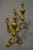 A pair of brass andirons.