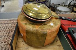 A bed warming pan and a leather pouffe.