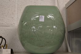 A large Korean green glazed pottery vase, relief moulded with deer in a landscape.