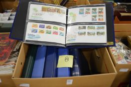 A box containing numerous albums of first day covers.