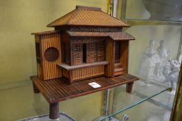 A Japanese bamboo model of a house.
