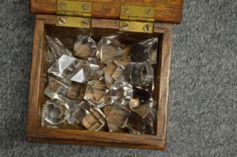 A small oak box containing crystal ornaments.