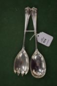 A pair of silver salad servers.