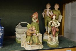 Four Royal Dux figure groups.