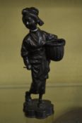 A Japanese cast metal figure of a lady carrying a basket.