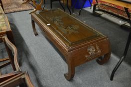 A Chinese carved hardwood coffee table with a small drawer.