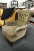 A Victorian button back armchair.