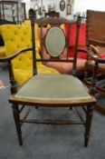 An Edwardian inlaid mahogany elbow chair.