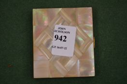 A mother-of-pearl inlaid compact.