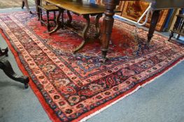 A Persian style carpet, red ground with floral decoration 295cms x 215cms.