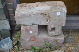 Two architectural stone elements.