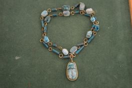 A scarab beetle necklace.
