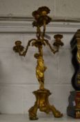 An ormolu three-branch, four-light figural candelabra.