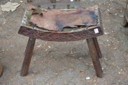 A carved wood stool.