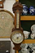 A large Victorian oak framed barometer / thermometer.