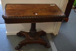 A 19th century rosewood D-shaped foldover card table on carved column support with concave sided