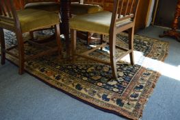 A Persian carpet, blue ground with stylized decoration depicting trees and animals etc. 265cms x